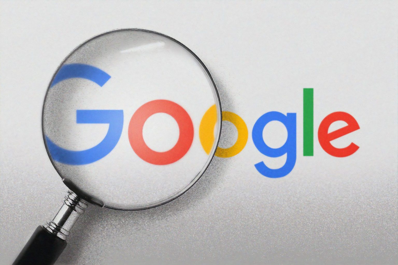 Google logo under a magnifying glass, highlighting the G Suite platform.