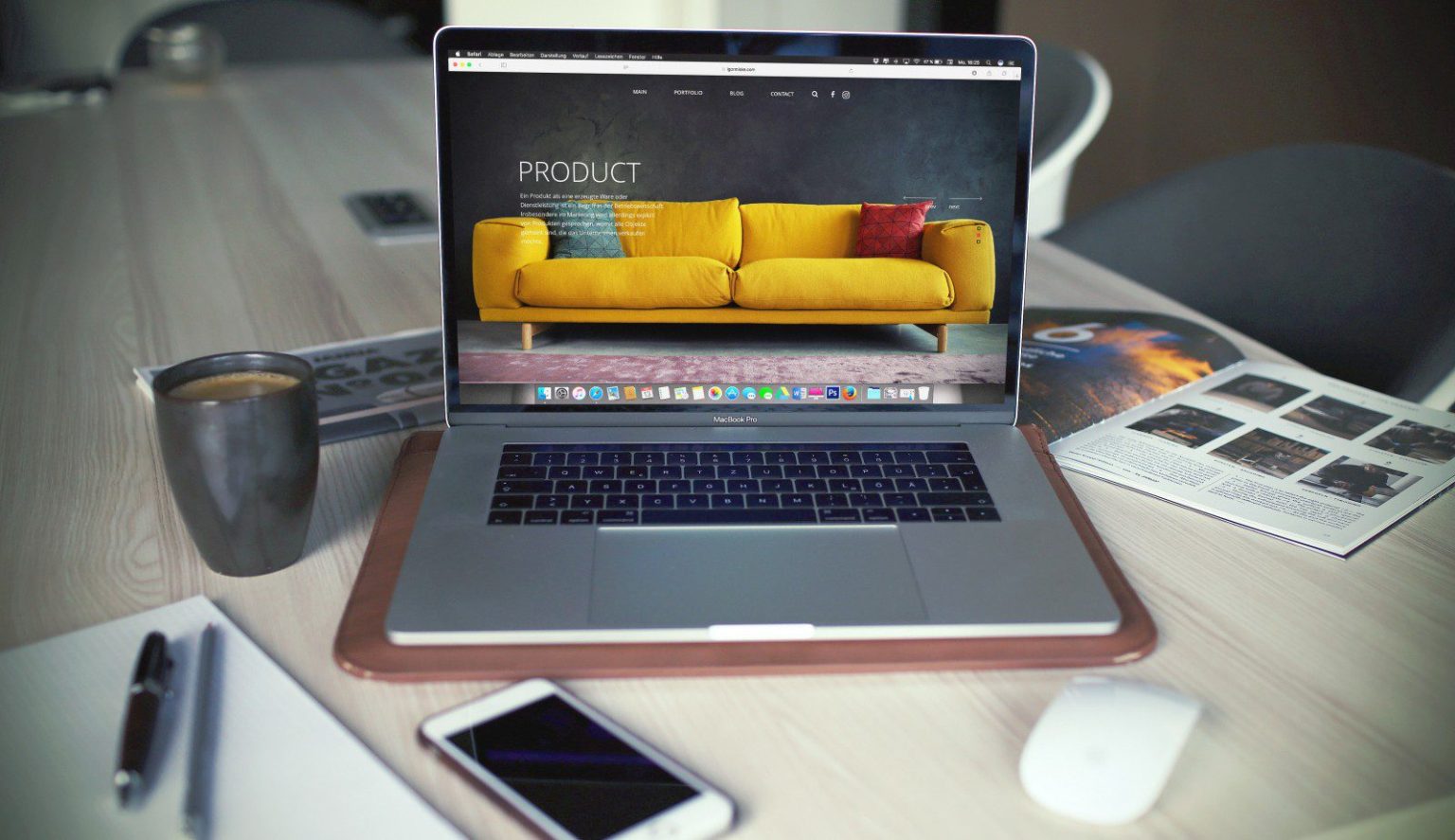 A laptop computer displaying a freelance vs agency web design comparison on a yellow couch.